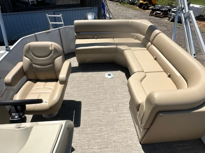 Slide: The Image of 2025 Godfrey Xperience 2086 CXP boat interior with beige seating and steering chair. - 19
