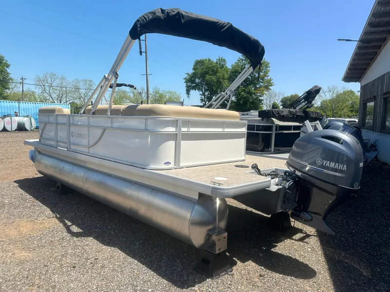 Slide: The Image of 2025 Godfrey Xperience 2086 CXP pontoon boat with Yamaha motor, parked outdoors. - 4