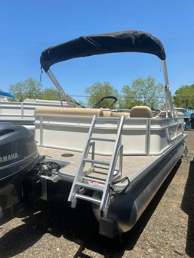 Slide: The Image of 2025 Godfrey Xperience 2086 CXP pontoon boat with Yamaha motor and ladder, outdoors. - 6