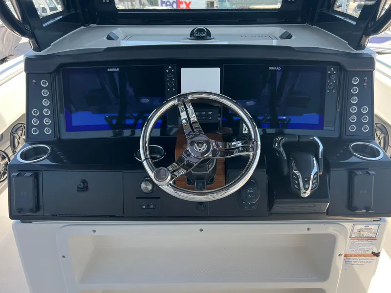 Slide: The Image of 2025 Robalo R300 Center Console boat interior with white and black seating. - 12