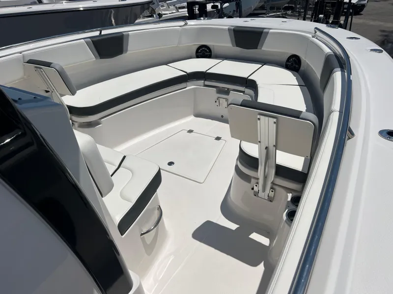 Slide: The Image of 2025 Robalo R300 Center Console boat with sleek white interior and seating. - 13
