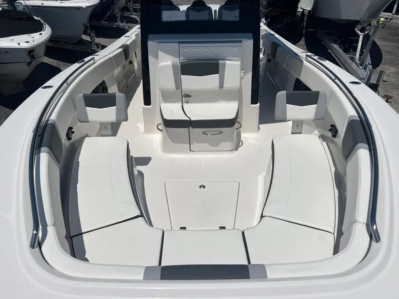 Slide: The Image of 2025 Robalo R300 Center Console interior with compact marine toilet and cushioned seating. - 14