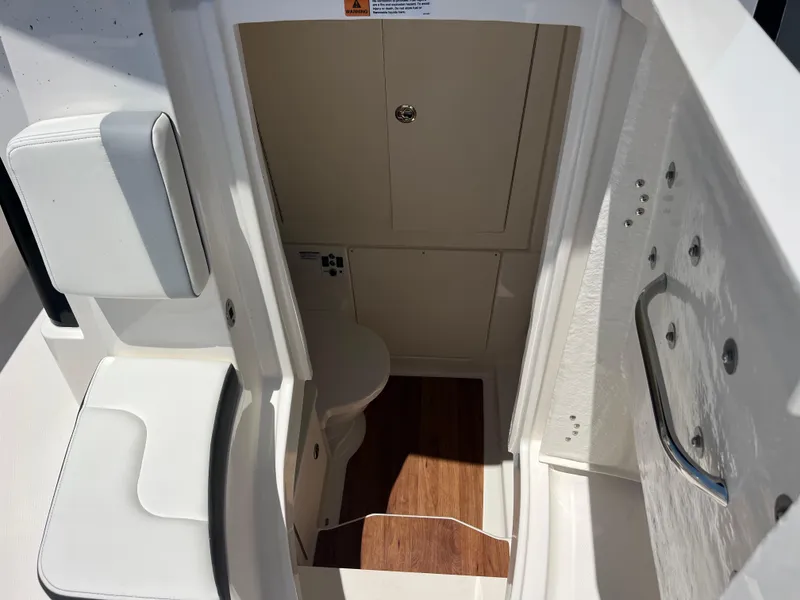 Slide: The Image of 2025 Robalo R300 Center Console boat bathroom with sink and toilet. - 15