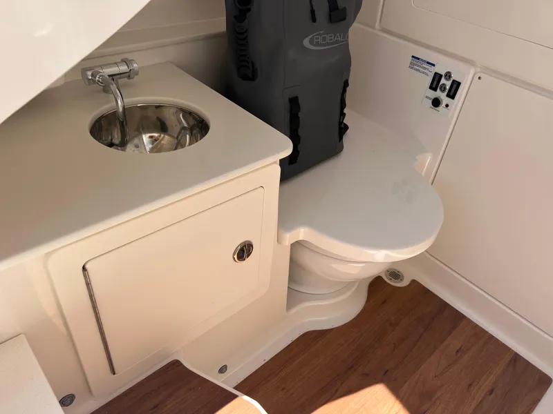 Slide: The Image of 2025 Robalo R300 Center Console interior with porthole and storage compartment. - 16