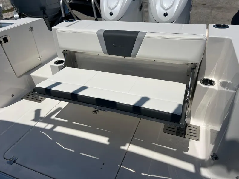 Slide: The Image of 2025 Robalo R300 Center Console boat with foldable seating and cup holders. - 20
