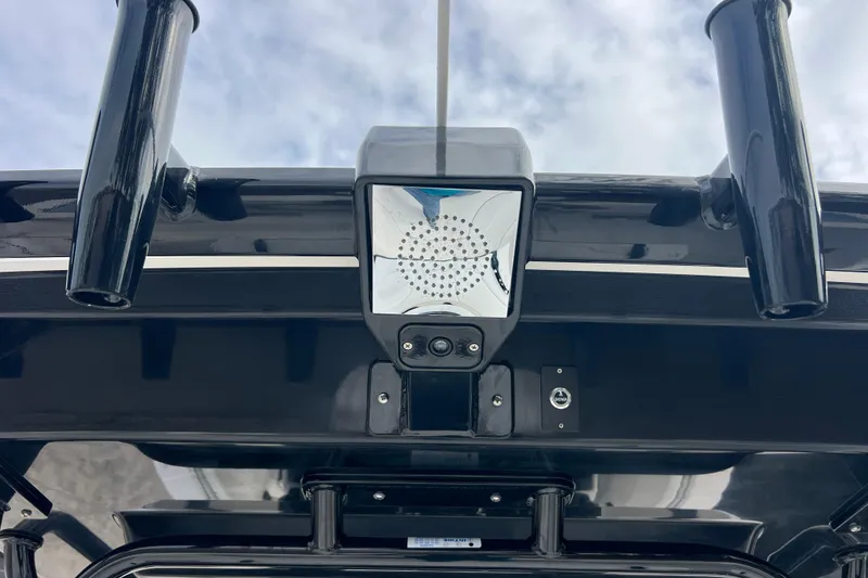 Slide: The Image of 2025 Robalo R300 Center Console boat with mounted equipment under cloudy sky. - 26