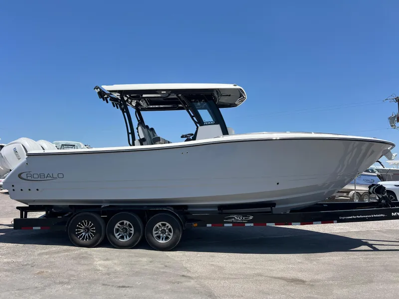 Slide: The Image of 2025 Robalo R300 Center Console boat on trailer, side view. - 3