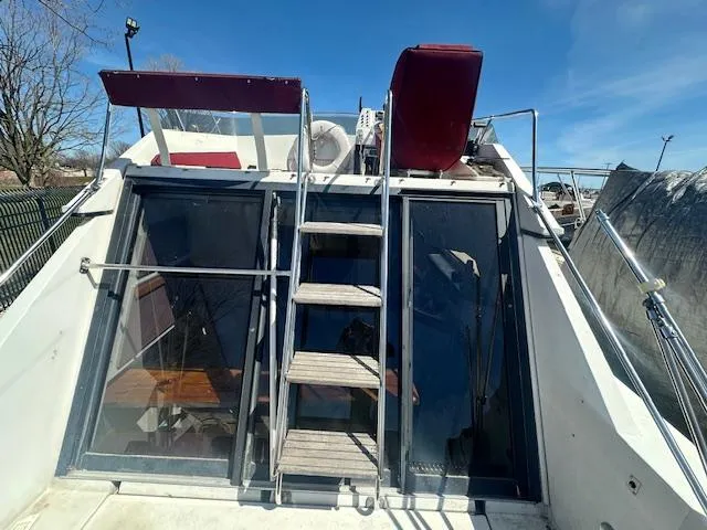 Slide: The Image of 1988 Carver 2767 Santego boat with ladder and glass doors under clear blue sky. - 11