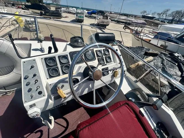Slide: The Image of 1988 Carver 2767 Santego boat helm with steering wheel and control panel. - 14