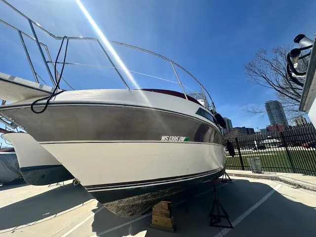 Slide: The Image of 1988 Carver 2767 Santego boat on dry dock under clear blue sky. - 2