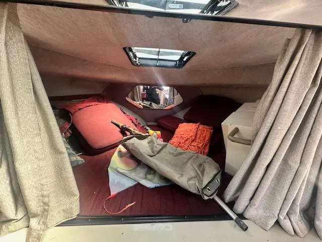 Slide: The Image of Interior cabin of 1988 Carver 2767 Santego boat with red cushions and curtains. - 23