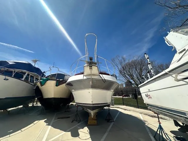 Slide: The Image of 1988 Carver 2767 Santego boat on stands under a clear blue sky. - 4