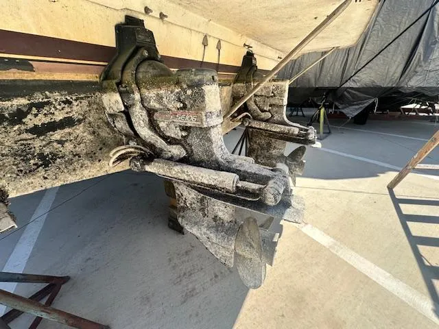 Slide: The Image of 1988 Carver 2767 Santego boat propellers with visible wear and marine growth. - 7