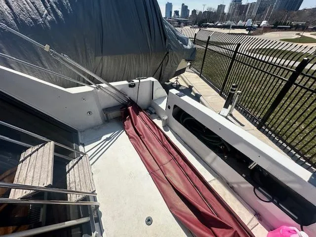 Slide: The Image of 1988 Carver 2767 Santego boat deck with city skyline in background. - 12