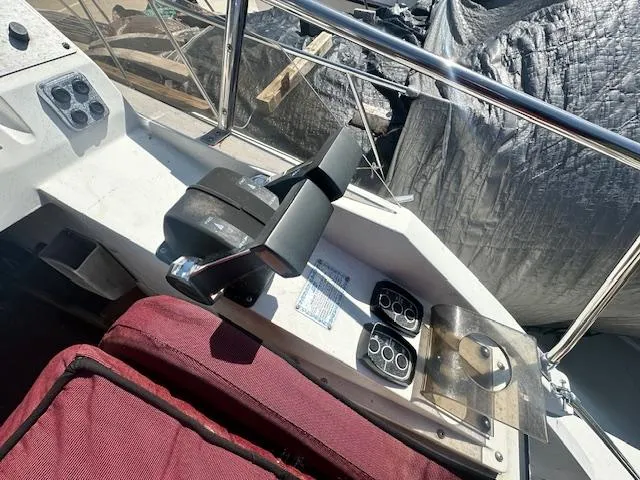 Slide: The Image of Control panel of 1988 Carver 2767 Santego boat with maroon seat and throttle lever. - 16