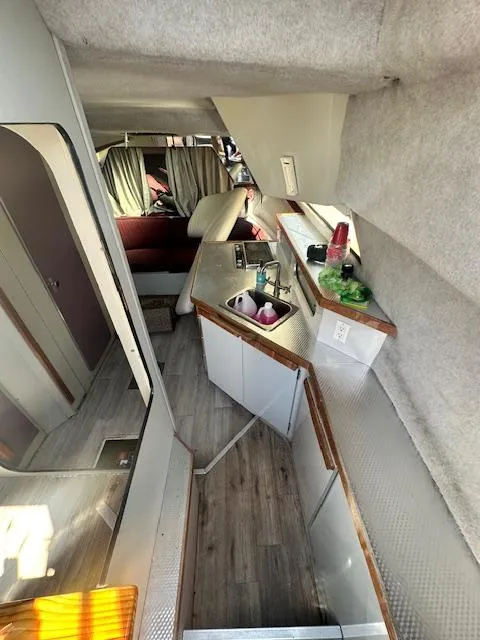 Slide: The Image of Interior of 1988 Carver 2767 Santego boat with kitchenette and seating area. - 19