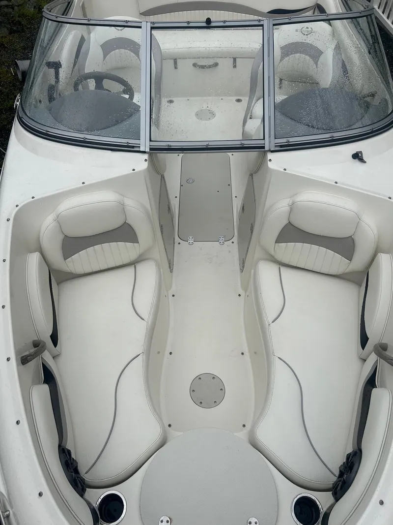 Slide: The Image of 2013 Stingray 208 LR boat interior with white seating and windshield. - 10