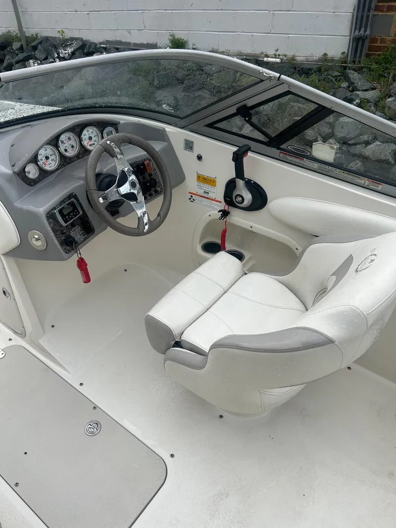 Slide: The Image of 2013 Stingray 208 LR boat interior with steering wheel and dashboard controls. - 12