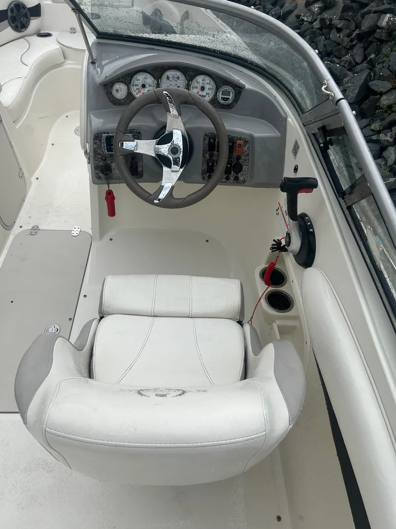Slide: The Image of 2013 Stingray 208 LR boat cockpit with steering wheel and gauges. - 17