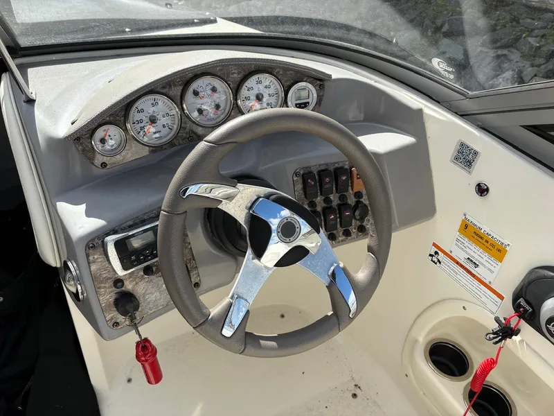 Slide: The Image of 2013 Stingray 208 LR boat dashboard with steering wheel and instrument panel. - 5
