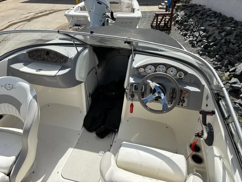 Slide: The Image of 2013 Stingray 208 LR boat interior with steering wheel and seating. - 7