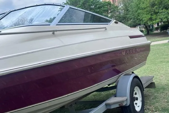 Slide: The Image of 1994 Maxum 2000 SC boat on trailer, featuring maroon and white exterior. - 6