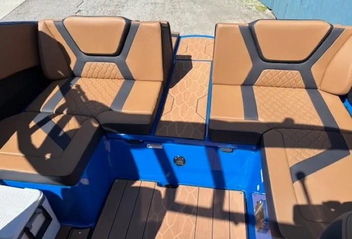 Slide: The Image of 2025 Yamaha Boats 222XD interior with brown and black seating, blue accents, and modern design. - 10