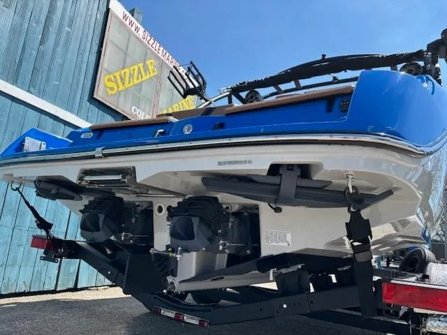 Slide: The Image of 2025 Yamaha Boats 222XD, blue and white, rear view with dual engines, on trailer. - 3