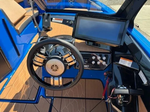 Slide: The Image of 2025 Yamaha Boats 222XD cockpit with steering wheel and touchscreen display. - 8