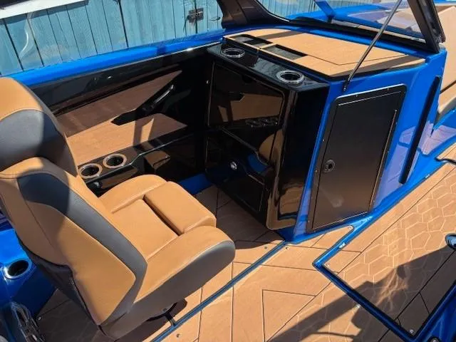 Slide: The Image of 2025 Yamaha Boats 222XD interior with tan seats and blue accents. - 9