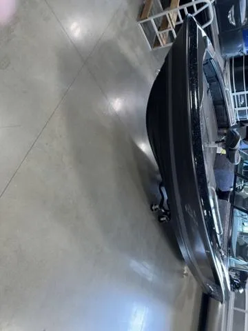 Slide: The Image of 2024 Lund 219 Pro-V GL Sport boat displayed indoors on a showroom floor. - 12