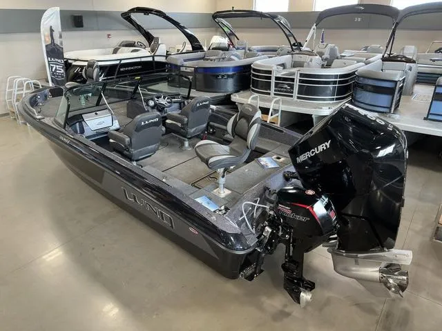 Slide: The Image of 2024 Lund 219 Pro-V GL Sport boat with Mercury engine in showroom display. - 5