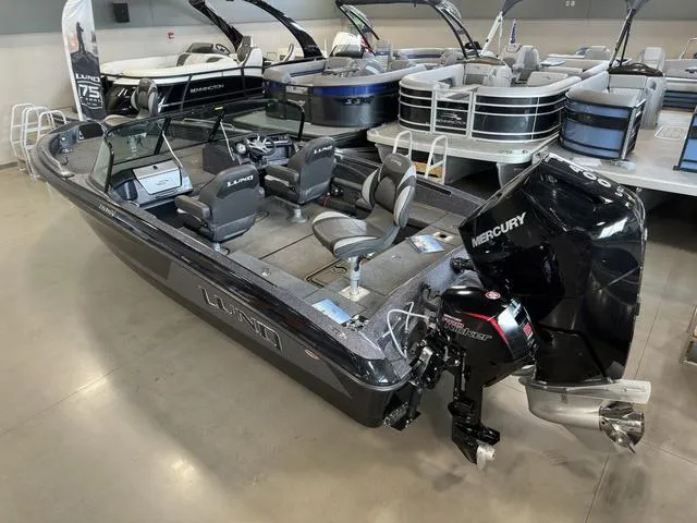 Slide: The Image of 2024 Lund 219 Pro-V GL Sport boat with Mercury engine in showroom. - 6