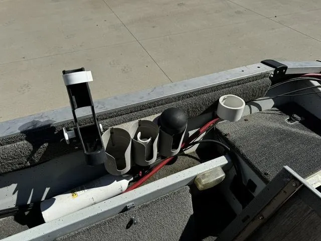 Slide: The Image of 1992 Tracker Super 17 Pro boat interior with rod holders and storage compartments. - 10