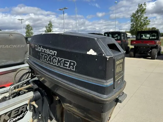 Slide: The Image of 1992 Tracker Super 17 Pro outboard motor, Johnson Tracker branding, parked outdoors. - 18