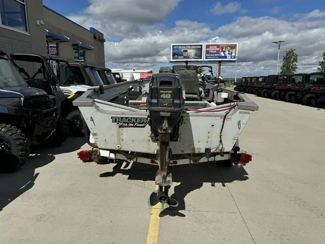 Slide: The Image of 1992 Tracker Super 17 Pro boat parked outdoors under a cloudy sky. - 4