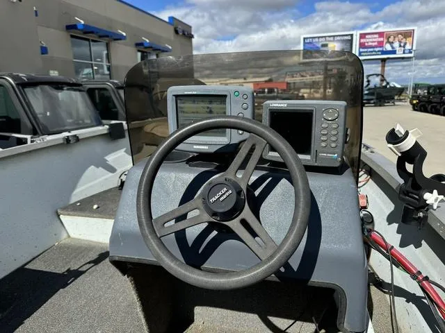 Slide: The Image of 1992 Tracker Super 17 Pro boat dashboard with steering wheel and navigation equipment. - 5
