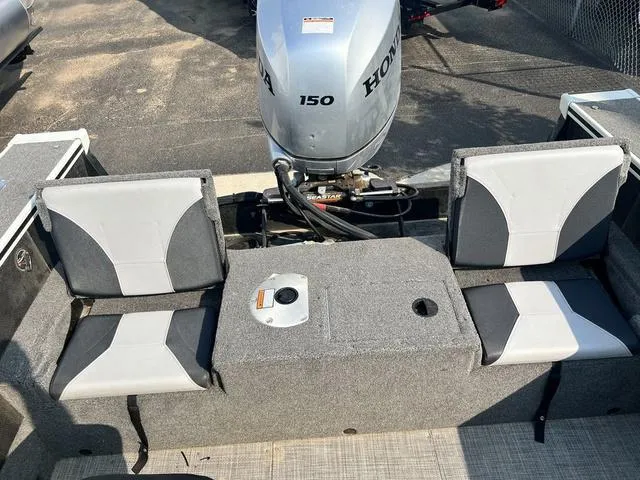 Slide: The Image of 2020 Alumacraft Trophy 185 boat interior with Honda 150 engine and two gray seats. - 11