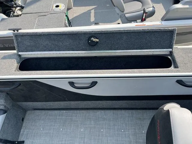 Slide: The Image of 2020 Alumacraft Trophy 185 boat interior with open storage compartment and seating. - 13