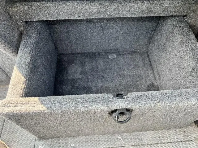 Slide: The Image of Open storage compartment in 2020 Alumacraft Trophy 185 boat, featuring gray carpeted interior. - 16