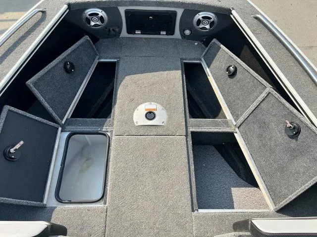 Slide: The Image of 2020 Alumacraft Trophy 185 boat interior with open storage compartments and speakers. - 18