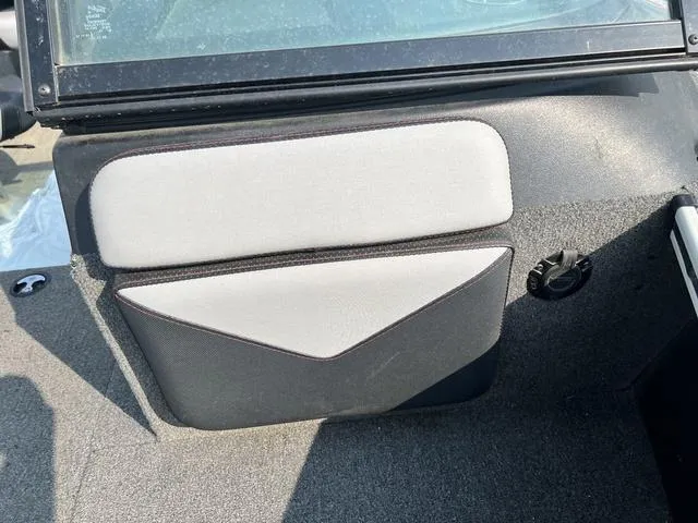 Slide: The Image of 2020 Alumacraft Trophy 185 interior detail with gray upholstery and storage compartment. - 19