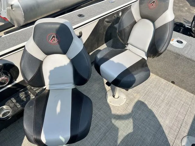 Slide: The Image of 2020 Alumacraft Trophy 185 boat seats, black and gray design, on a textured deck. - 20