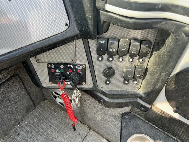 Slide: The Image of Control panel of a 2020 Alumacraft Trophy 185 boat with switches and ignition keys. - 9