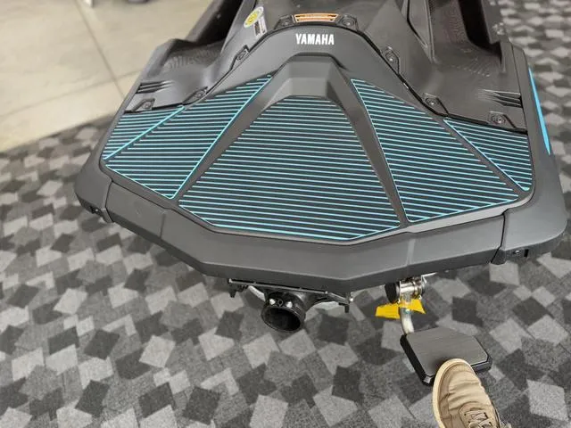 Slide: The Image of 2025 Yamaha Waverunner Jetblaster, sleek design, black and blue accents, on display indoors. - 6