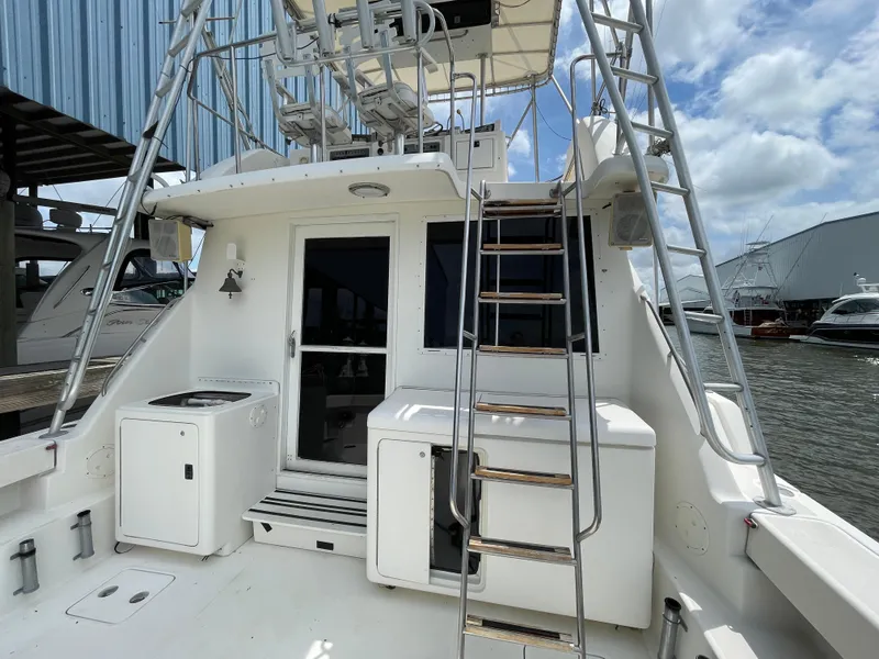 Slide: The Image of 1990 Tiara Yachts 4300 Convertible boat deck with ladder and storage compartments. - 14