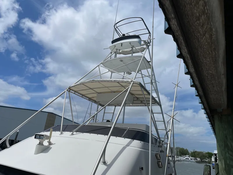 Slide: The Image of 1990 Tiara Yachts 4300 Convertible with tower against a cloudy sky. - 16