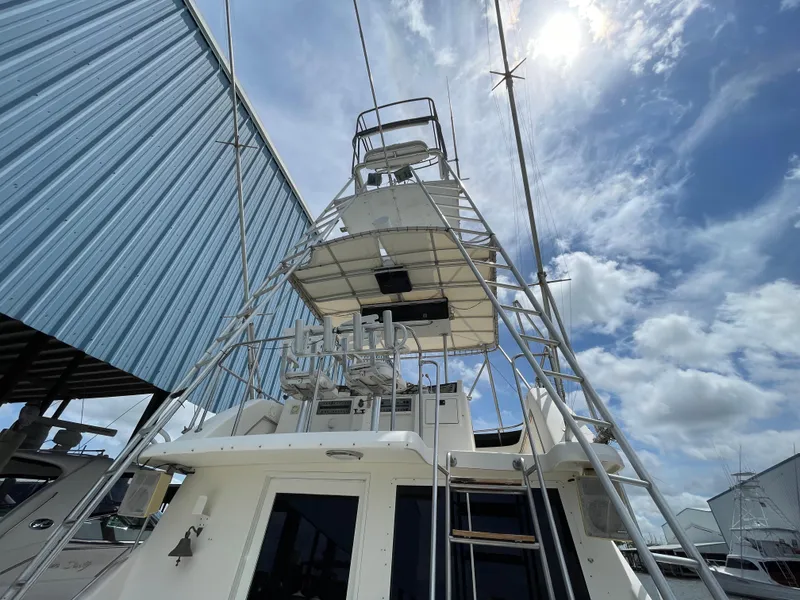 Slide: The Image of 1990 Tiara Yachts 4300 Convertible, tower view under a partly cloudy sky. - 20