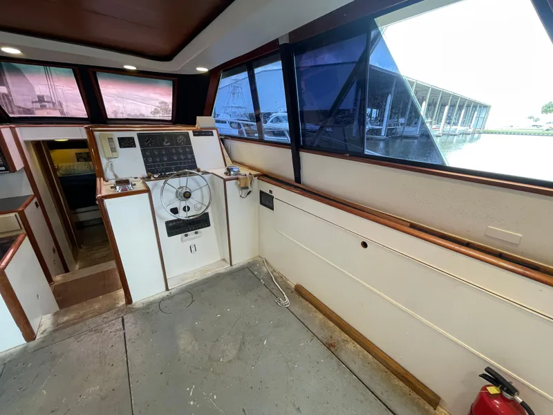 Slide: The Image of 1990 Tiara Yachts 4300 Convertible interior helm with panoramic windows and control panel. - 29