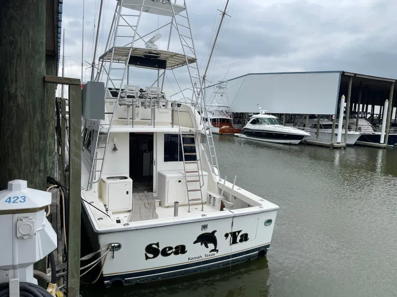 Slide: The Image of 1990 Tiara Yachts 4300 Convertible docked at marina, rear view. - 3